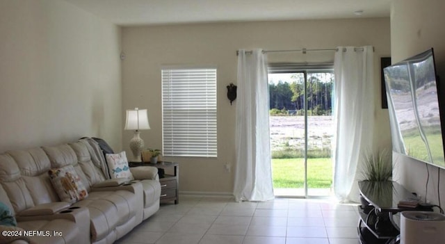 living room featuring baseboards and light tile patterned flooring