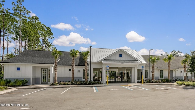 view of building exterior featuring uncovered parking and fence