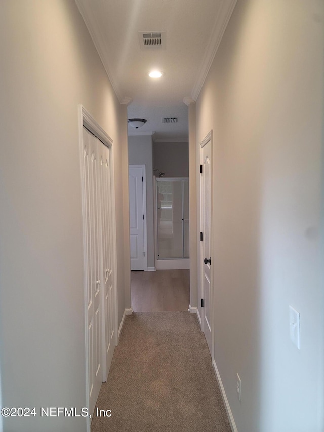 hall featuring crown molding and carpet