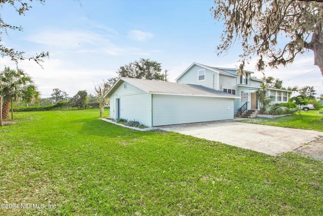 view of front of house featuring a front yard, an outbuilding, and a garage