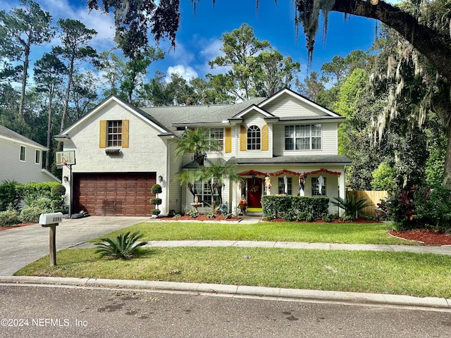 view of front of property featuring a front yard, a garage, and a porch