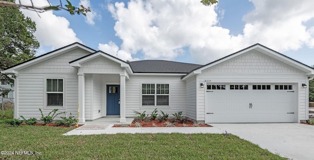 view of front of house with a front yard and a garage