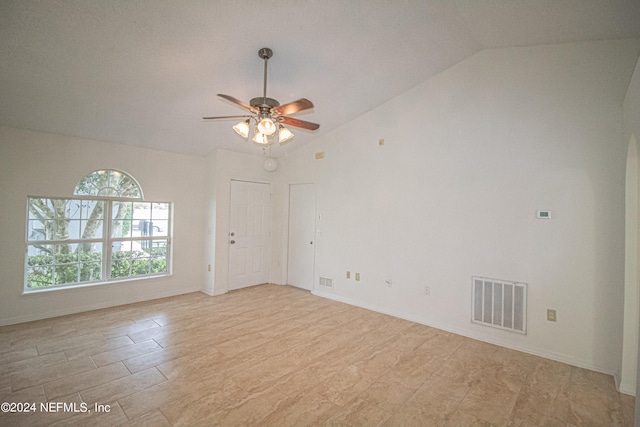 empty room featuring ceiling fan and lofted ceiling