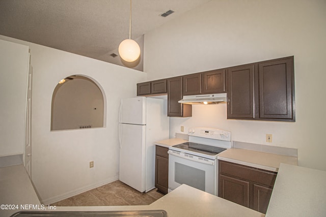 kitchen featuring white appliances, a textured ceiling, dark brown cabinetry, decorative light fixtures, and high vaulted ceiling