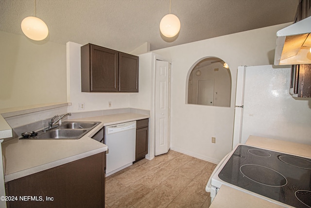 kitchen featuring white appliances, sink, dark brown cabinets, and pendant lighting