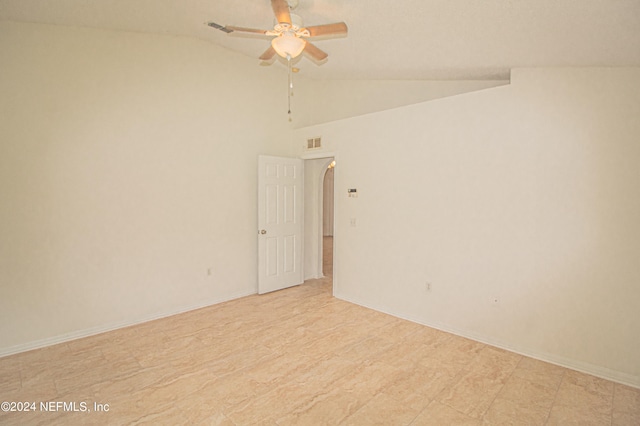 empty room with ceiling fan and high vaulted ceiling