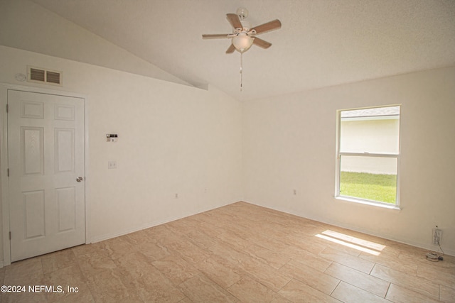 unfurnished room featuring ceiling fan, a textured ceiling, and lofted ceiling