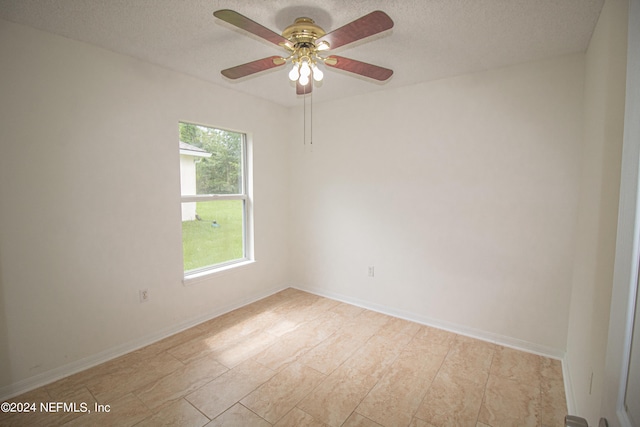 spare room with a textured ceiling, light wood-type flooring, and ceiling fan