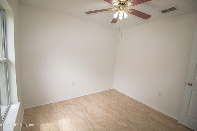 spare room featuring light hardwood / wood-style flooring, a textured ceiling, and ceiling fan