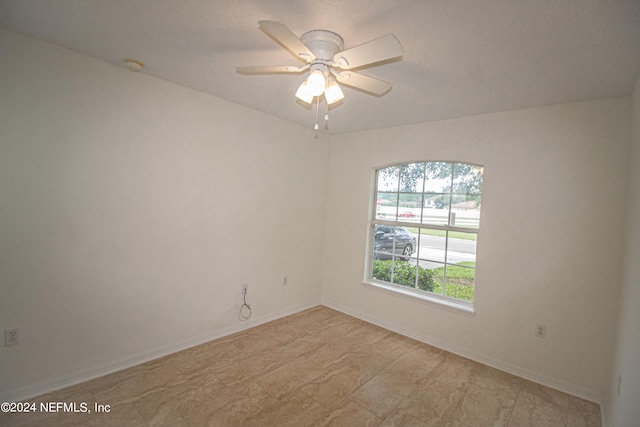 unfurnished room with a textured ceiling and ceiling fan