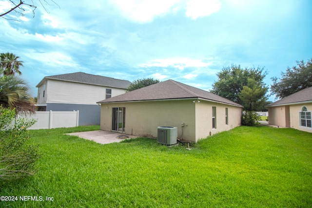 back of property with a patio area, a lawn, and central AC unit