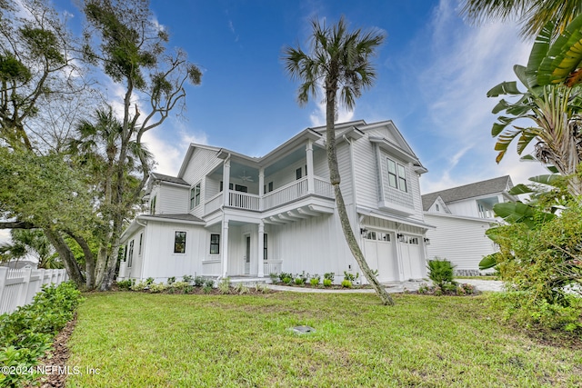 view of front of house with a front yard, a balcony, and a garage