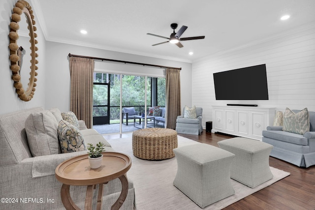 living room with ornamental molding, dark hardwood / wood-style floors, and ceiling fan