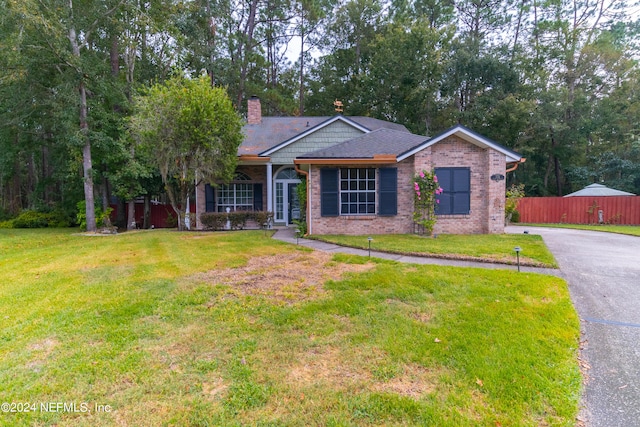 ranch-style house with a front lawn