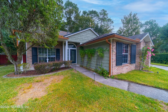 ranch-style home with a front lawn