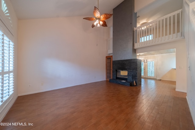 unfurnished living room with high vaulted ceiling and a wealth of natural light