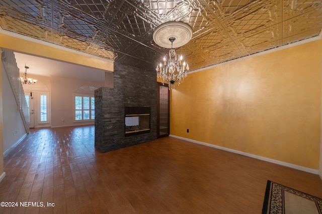 unfurnished living room with crown molding, wood-type flooring, and a high ceiling