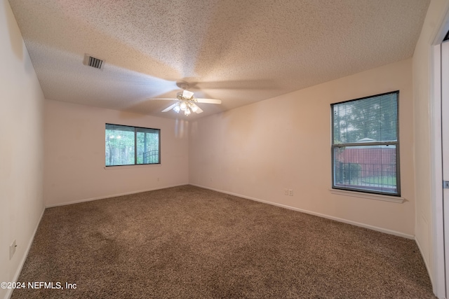 carpeted empty room with a textured ceiling and ceiling fan