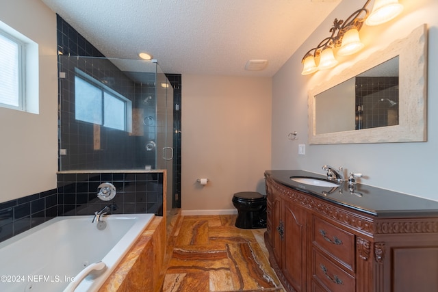 full bathroom featuring toilet, a textured ceiling, plus walk in shower, and vanity