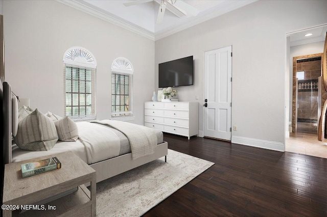 bedroom featuring ceiling fan, beamed ceiling, dark hardwood / wood-style floors, crown molding, and a towering ceiling