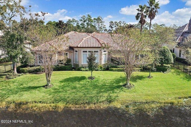 mediterranean / spanish house with a front lawn