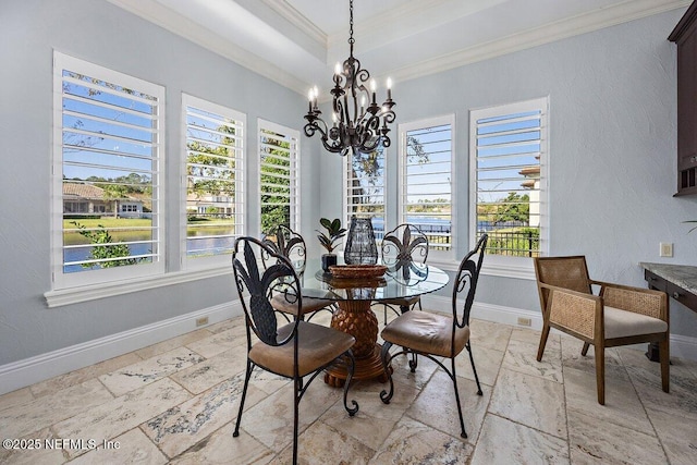 dining space featuring crown molding, plenty of natural light, and a notable chandelier