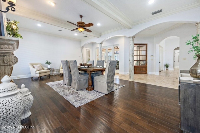 dining area featuring ornate columns, ornamental molding, ceiling fan, beam ceiling, and hardwood / wood-style flooring