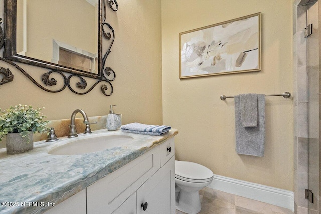 bathroom with tile patterned floors, vanity, and toilet