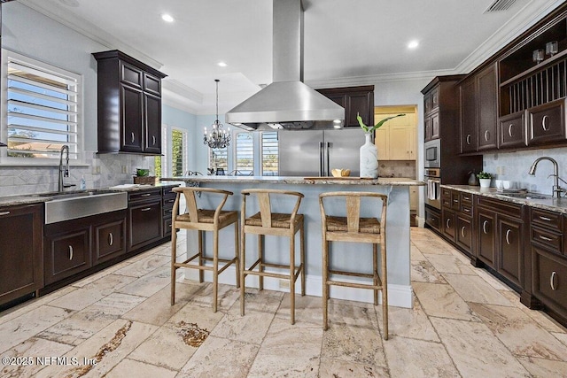 kitchen with a center island, stainless steel appliances, tasteful backsplash, and island range hood