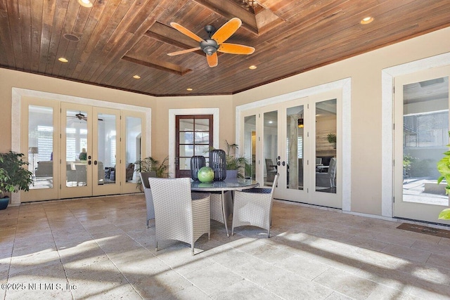 unfurnished sunroom featuring french doors, ceiling fan, and wooden ceiling