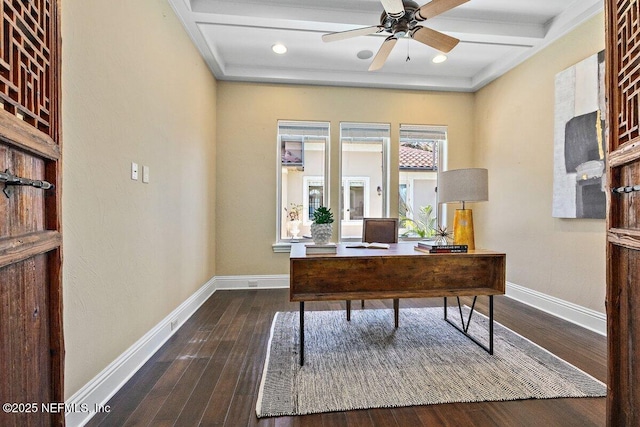 unfurnished office with dark hardwood / wood-style floors, ceiling fan, and coffered ceiling