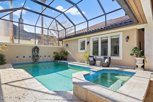 view of pool featuring a lanai and an in ground hot tub