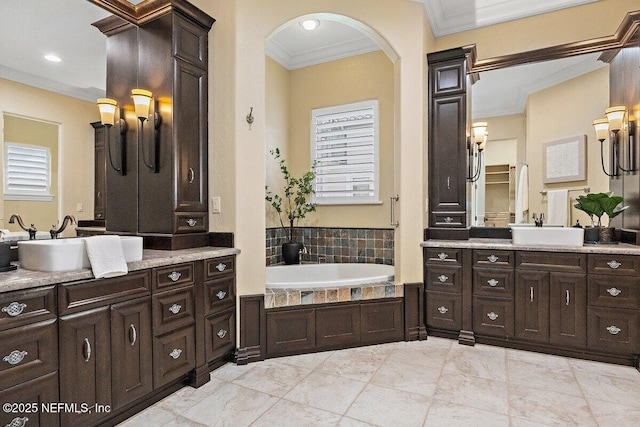 bathroom featuring vanity, a healthy amount of sunlight, and crown molding