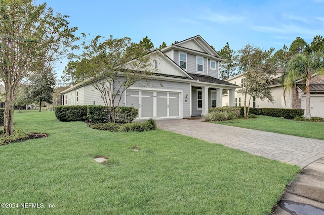 view of front of house with a front yard and a garage