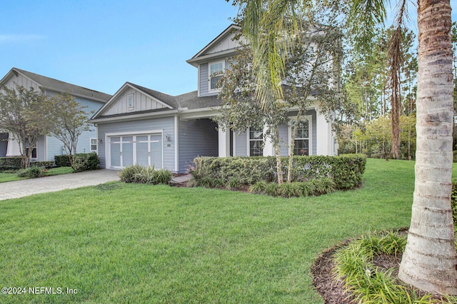 view of front of house with a front yard and a garage