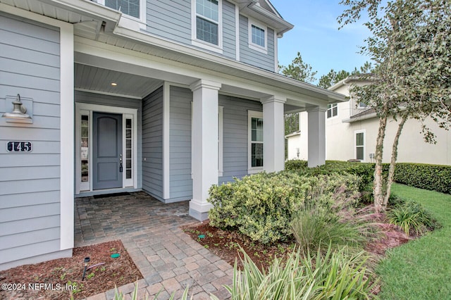 view of exterior entry with covered porch