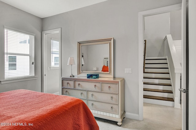 bedroom featuring light colored carpet