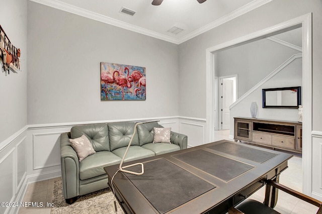 living room with ceiling fan and ornamental molding