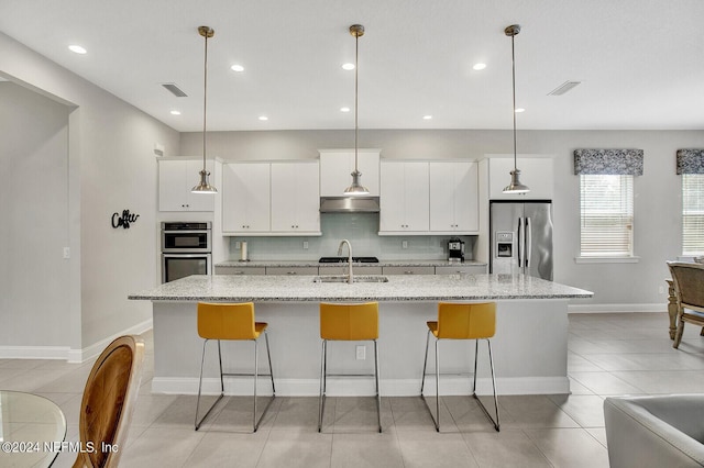 145 Sugar Sand Ln, Saint Johns, FL 32259 - kitchen with backsplash, a large island, visible vents, appliances with stainless steel finishes, and white cabinetry