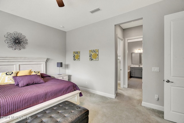 carpeted bedroom with connected bathroom and ceiling fan