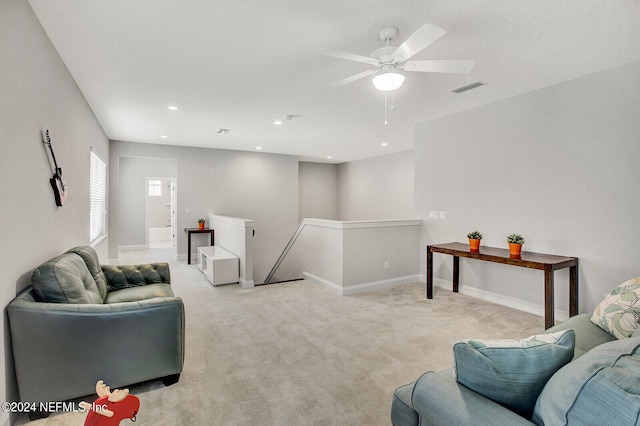 carpeted living room with ceiling fan