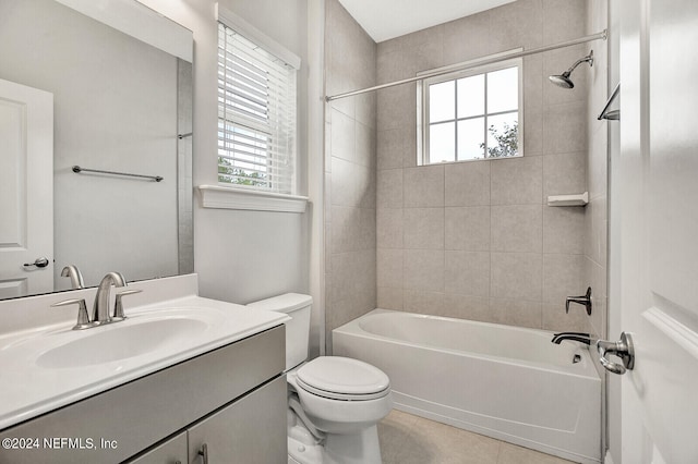 full bathroom featuring vanity, toilet, plenty of natural light, and tiled shower / bath