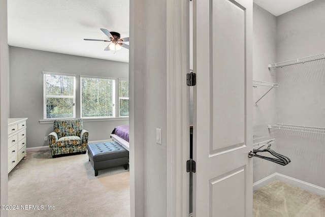 interior space with light colored carpet and ceiling fan