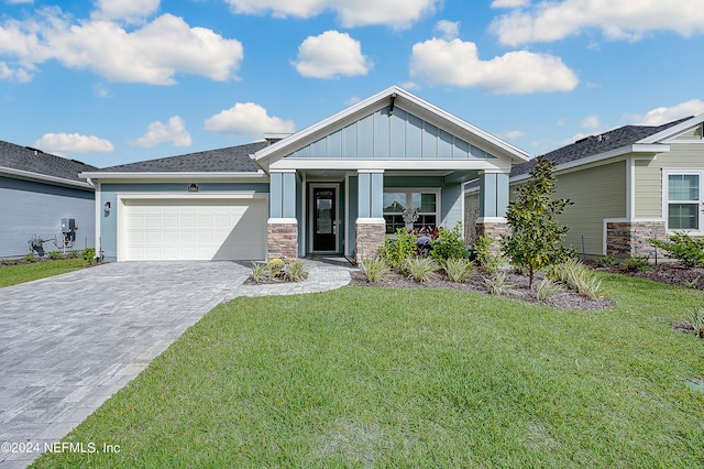 craftsman inspired home featuring a front lawn and a garage