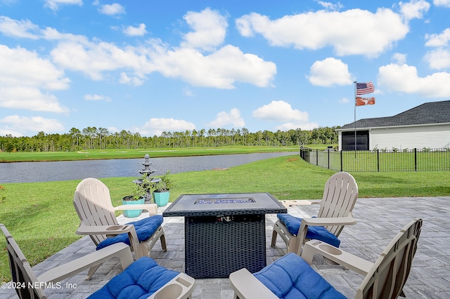 view of patio / terrace with an outdoor fire pit and a water view