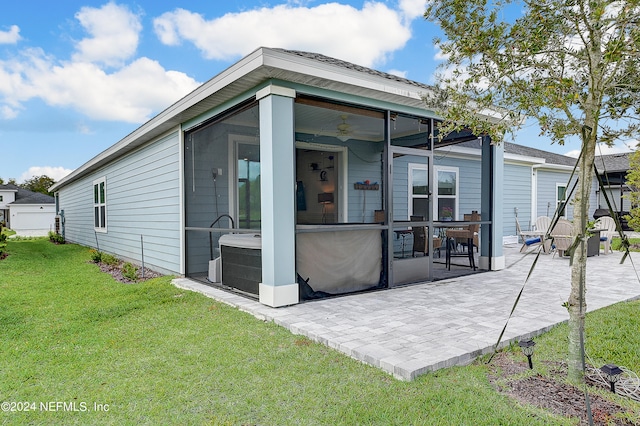 rear view of house featuring a patio area, a yard, and ceiling fan