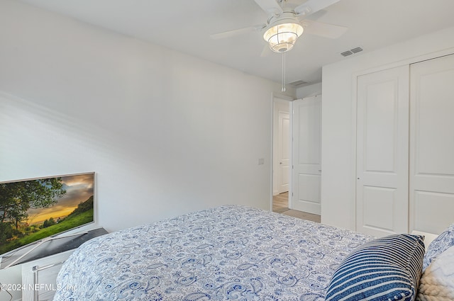 bedroom featuring hardwood / wood-style flooring, a closet, and ceiling fan