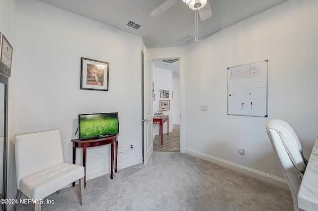 sitting room with light carpet and ceiling fan