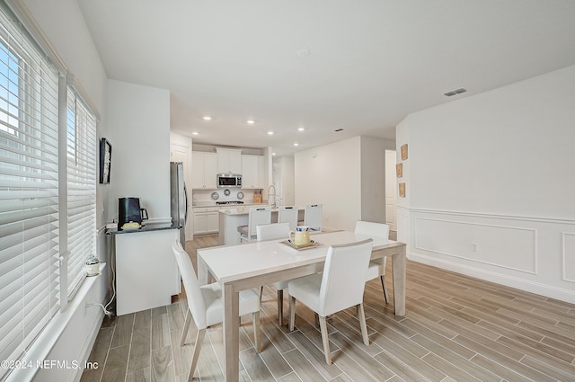 dining space featuring light hardwood / wood-style flooring