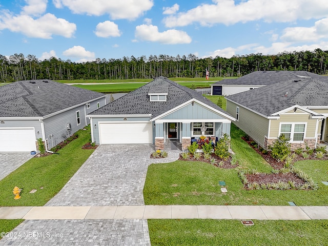 view of front of house with a porch, a front lawn, and a garage